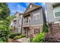 Stylish townhome with stone facade, gray siding, and a cozy front patio at 3005 Devoncroft Se St, Smyrna, GA 30080