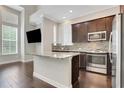 Modern kitchen featuring stainless steel appliances, granite countertops, and a center island at 3005 Devoncroft Se St, Smyrna, GA 30080