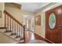 Elegant foyer featuring hardwood floors, staircase, and a decorative front door with glass detailing at 878 Park Creek Sw Ct, Marietta, GA 30064