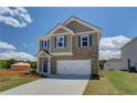 Beautiful two-story home with brick and siding, a two-car garage, and a paved driveway at 17 Camellia Dr, Fairburn, GA 30213