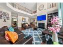 Elegant living room featuring high ceilings, a fireplace, and a cozy seating area with leather furniture at 4060 Brumby Ln, Cumming, GA 30041