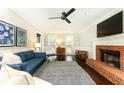 Bright living room featuring a brick fireplace, hardwood floors, and stylish decor at 511 Pine Springs Se Trl, Marietta, GA 30067