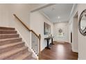 Stairway and entryway with wood floors, complemented by a decorative table and stylish accents, creating a welcoming atmosphere at 122 Grove View Rd, Woodstock, GA 30189