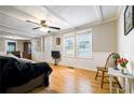 Bright living room with hardwood floors, white trim, and neutral wall paint at 4067 Lenora Church Rd, Snellville, GA 30039