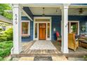 Inviting front porch with seating area, wooden door, and decorative details create a cozy outdoor space at 549 Atwood Sw St, Atlanta, GA 30310