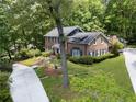 Aerial view of a beautiful brick home with a well-manicured lawn and a private driveway at 2719 Cravey Ne Dr, Atlanta, GA 30345