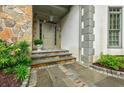 Elegant front door with stone accents and manicured landscaping at 5318 Brooke Farm Dr, Dunwoody, GA 30338