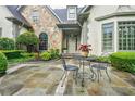 Beautiful home entrance featuring a stone facade and outdoor seating at 5318 Brooke Farm Dr, Dunwoody, GA 30338