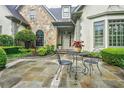 Charming front entrance features a stone facade and a cozy seating area at 5318 Brooke Farm Dr, Dunwoody, GA 30338