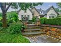 Landscaped front yard with stone steps and lush greenery at 5318 Brooke Farm Dr, Dunwoody, GA 30338
