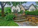 Beautifully landscaped front yard with stone accents and manicured greenery at 5318 Brooke Farm Dr, Dunwoody, GA 30338