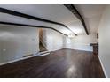 Open-concept living room featuring wood floors, neutral paint, and staircase access at 6225 Pebble Dr, Douglasville, GA 30135