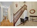Welcoming foyer with hardwood floors, a staircase, and stylish decor creating a warm atmosphere at 1236 Whitlock Ridge Sw Dr, Marietta, GA 30064