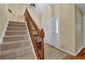 Well-lit staircase leading to the upper level, featuring carpeted steps and wooden railings at 1236 Whitlock Ridge Sw Dr, Marietta, GA 30064