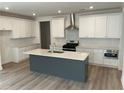 Modern kitchen boasts a large island, stainless steel appliances, and ample cabinet space at 241 Saratoga Dr, Acworth, GA 30102