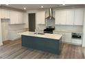 Modern kitchen with white cabinets, stainless steel appliances, and a large island with a sink at 241 Saratoga Dr, Acworth, GA 30102