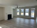 Bright living room features a fireplace, ceiling fan, and large windows at 241 Saratoga Dr, Acworth, GA 30102