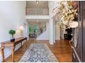 Grand foyer with hardwood floors, staircase, and view of the living spaces at 265 Dogwood Walk Ln, Norcross, GA 30071