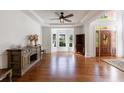 Bright living room featuring hardwood floors, wet bar and large windows at 265 Dogwood Walk Ln, Norcross, GA 30071