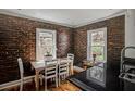 Bright dining room with hardwood floors, exposed brick wall and table with chairs by the windows at 3330 W Shadowlawn Ne Ave, Atlanta, GA 30305