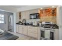Stylish kitchen featuring stainless steel appliances, white cabinets, granite countertops and exposed brick wall at 3330 W Shadowlawn Ne Ave, Atlanta, GA 30305