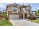 Attractive home featuring a two-car garage, well-manicured lawn, and appealing stone and siding accents at 4650 Silver Meadow Dr, Buford, GA 30519