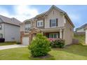 Beautiful two-story home with a well-kept lawn, stone details, and a convenient two-car garage at 4650 Silver Meadow Dr, Buford, GA 30519