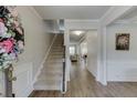 Inviting foyer with hardwood floors, a staircase, and elegant molding throughout the entryway at 4650 Silver Meadow Dr, Buford, GA 30519