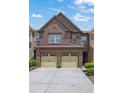 Charming brick townhome featuring a two-car garage and well-maintained landscaping at 1929 Brightleaf Way, Marietta, GA 30060
