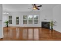 Bright living room with a fireplace, a ceiling fan, and large windows offering plenty of natural light at 1929 Brightleaf Way, Marietta, GA 30060