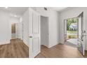 Inviting entryway with wood-look floors, white walls and trim, and an open front door at 22 Foothills Trl, Sharpsburg, GA 30277