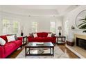 Inviting living room with fireplace, hardwood floors, and ample natural light from shuttered windows at 320 Kirk Rd, Decatur, GA 30030