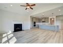 Open-concept living space with fireplace that flows into a modern kitchen with island seating at 178 Haverling Pass, Hampton, GA 30228