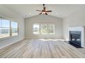Bright living room with vaulted ceilings, a fireplace, and large windows offering ample natural light at 178 Haverling Pass, Hampton, GA 30228