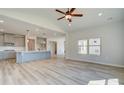 Open-concept living area flows into a modern kitchen, creating an inviting and connected space at 178 Haverling Pass, Hampton, GA 30228