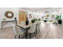 Sunlit open-concept living space featuring dining area and living room with modern decor at 6054 Heritage Se Way, Mableton, GA 30126