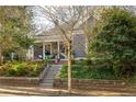 Attractive home with a cozy front porch and a well-manicured landscape at 629 Hansell Se St, Atlanta, GA 30312