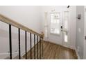 Bright entryway featuring hardwood floors, a staircase, and a glass-paneled front door at 10162 Benton Woods Dr, Covington, GA 30014