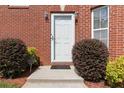 Inviting front door with neat landscaping and a 'No Soliciting' sign at 1127 Oak Hollow Ct, Hampton, GA 30228
