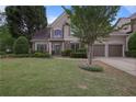 Beautiful home boasting a well-maintained lawn and a two-car garage, set within a peaceful and verdant surrounding landscape at 1199 Kenway Se Cir, Smyrna, GA 30082