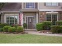Close-up highlighting a welcoming front door framed by manicured landscaping, stone accents, and an inviting walkway at 1199 Kenway Se Cir, Smyrna, GA 30082
