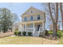 Inviting two-story home with a cozy front porch and lush green lawn at 1303 Hill Se St, Atlanta, GA 30315