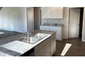 A kitchen with granite countertops, stainless steel appliances, and white cabinets for ample storage at 3925 Fairhaven Rd, Lithia Springs, GA 30122