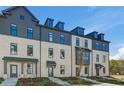 Striking townhome featuring classic architectural details and a professionally landscaped front yard at 525 Rubato Knl, Mcdonough, GA 30253