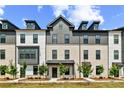 Charming multi-story townhome with a mix of brick and siding, showcasing a well-maintained front yard at 525 Rubato Knl, Mcdonough, GA 30253