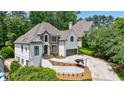 Beautiful two-story home with a well-maintained front yard and elegant architectural details at 1021 Wetherby Way, Alpharetta, GA 30022