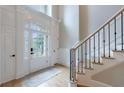 Elegant foyer with a staircase, white paneled walls, and plenty of natural light at 1021 Wetherby Way, Alpharetta, GA 30022