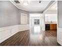 Spacious dining room with modern flooring, wainscoting, and views of the kitchen at 1954 Durwood Ln, Duluth, GA 30096
