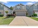 Charming two-story home with a gray garage door, stone accents, and a well-manicured lawn at 3255 Morgan Rd, Buford, GA 30519