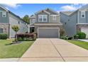 Charming two-story home featuring a stone facade, neutral color palette, well-manicured lawn, and an attached two-car garage at 3255 Morgan Rd, Buford, GA 30519